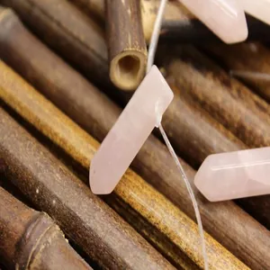 Macro view of a natural pink rose quartz hexagonal column bead for DIY jewelry making