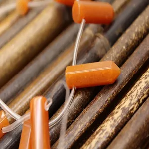 Detailed view of 30x8mm orange red aventurine cylinder beads for DIY jewelry making