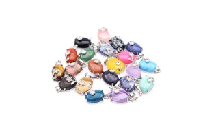 Macro view of assorted natural stone oval pendants featuring silver flower decorative accents