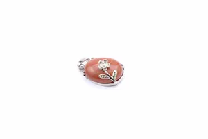Detail of elegant brown goldstone oval pendant with silver flower detail for jewelry