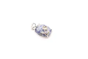 Close-up detail of a blue mottled natural stone pendant with silver floral accent
