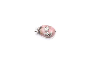 Close-up of pink natural stone pendant with silver rose flower detail