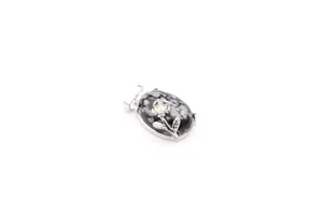 Detail shot of an oval snowflake obsidian pendant with a silver rose motif on white