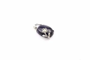 Detailed view of dark blue sandstone oval pendant featuring a silver floral design