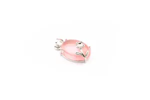 Macro detailed view of oval pink rose quartz pendant with silver floral decorative accents