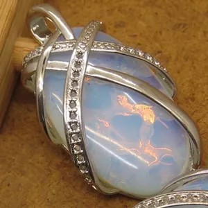 Elegant natural stone pendant necklace with crystal-encrusted silver cage design.