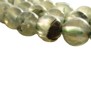Macro view of high-quality AAA natural green prehnite gemstone beads for DIY crafts.