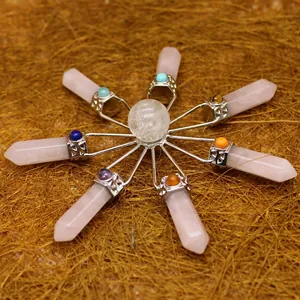 Handcrafted rose quartz crystal grid ornament with a central clear quartz sphere