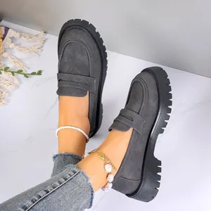 Grey suede platform loafers with lug sole and pearl anklet detail showing on marble