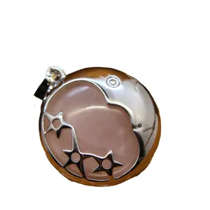 Elegant rose quartz crystal pendant with silver crescent moon and stars design