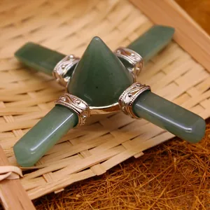 Green aventurine crystal pyramid ornament with silver metal accents on bamboo tray