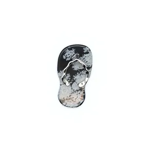 Detailed macro view of a snowflake obsidian flip-flop pendant charm with silver wavy strap