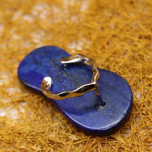 Unique slipper-shaped lapis lazuli crystal pendant with silver wavy strap detail