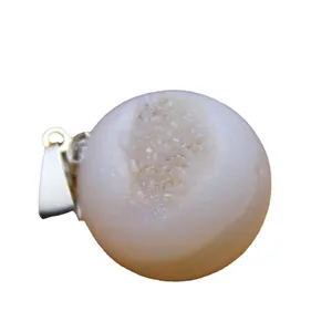 Natural raw agate druzy egg pendant with sparkling crystal opening on white background.