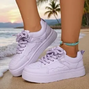 Trendy 2026 purple platform sneakers with chunky soles and lace-up design on beach