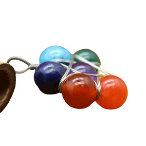 Handmade ethnic style wire wrapped pendant with colorful chakra crystal beads.
