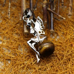 Elegant silver fairy pendant holding a natural tiger eye crystal ball on a rustic background