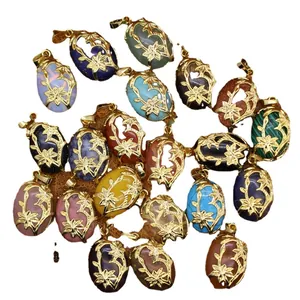 Collection of ethnic style oval gemstone pendants with intricate gold floral filigree