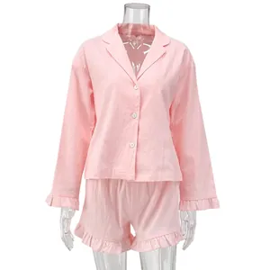 Front view of a pink long-sleeve cotton loungewear set with ruffled shorts
