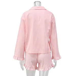 Back view of pink cotton loungewear set with ruffled long sleeve top and shorts