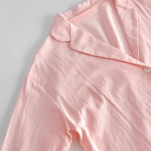 Close-up of pink cotton loungewear cardigan with lapel collar and soft texture.