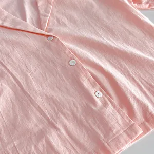 Macro view of pink pure cotton loungewear top showing fabric texture and buttons