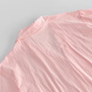 Close-up detail of pink pure cotton fabric and collar on women's home wear cardigan