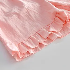 Detailed close-up showing the soft ruffle hem and cotton texture of pink home wear