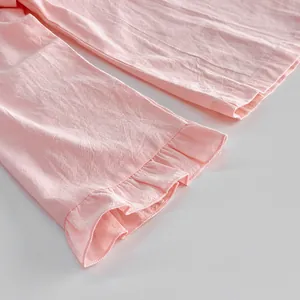 Detailed macro view showing the ruffled hem of a sweet pink pure cotton loungewear sleeve