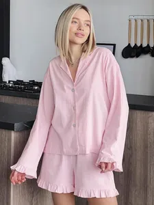 Elegant pink cotton two-piece loungewear set featuring ruffled long sleeve shirt and shorts