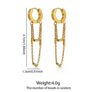 Detail view of gold stainless steel hoop earrings with chain tassels and beads.
