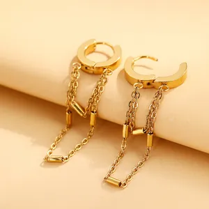 Close-up of golden stainless steel hoop earrings with elegant tassel chain details