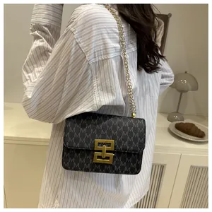 Detail view of a women's vintage printed square bag with elegant gold chain strap