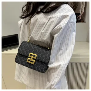 Detailed close-up of a women's vintage monogram crossbody bag with gold chain strap