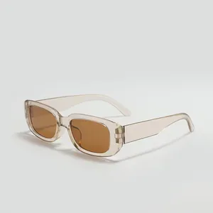 Perspective view of square sunglasses with beige transparent frame and brown lenses