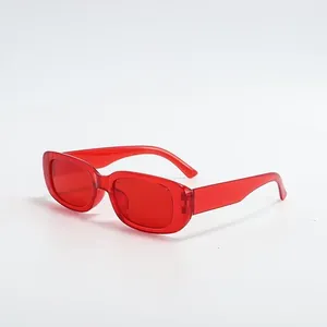 Detailed side view of trendy translucent red rectangular sunglasses for streetwear