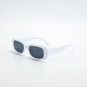 Detail showing white small frame square sunglasses with dark lenses for fashion street photography.