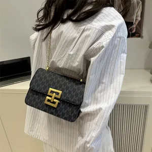 Retro chic small square crossbody bag with all-over monogram print and gold chain strap