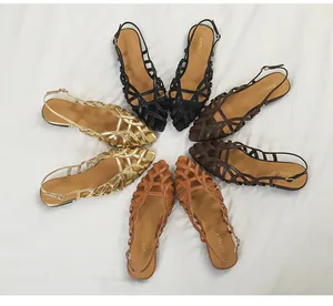 Detailed overhead view of woven Roman flat sandals in multiple fashion colors