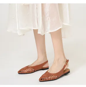 Elegant brown woven pointed-toe slingback flats shown on model with a white skirt