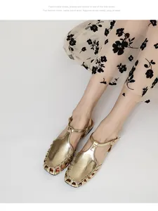 Detailed view of gold metallic hollow-out sandals with a French retro aesthetic on model