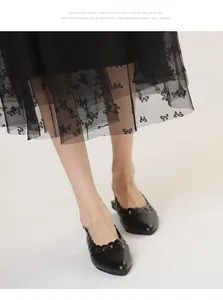 Detailed macro shot of vintage black hollowed-out pointed toe slingback flat sandals