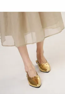 Detailed view of vintage gold pointed-toe flat sandals with hollow-out pattern