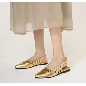 Close-up of vintage gold hollow-out pointed-toe slingback flat sandals for women