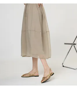 Close-up of elegant gold woven Roman flat sandals for summer style
