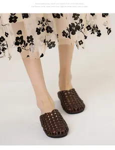 Detalle de sandalias tipo mule planas trenzadas marrones con puntera cerrada.