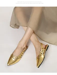 Close-up detail of vintage gold hollow-out pointed-toe slingback flat sandals worn by a model