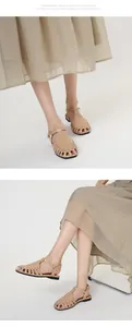 Detail view of beige French vintage hollow-out breathable Roman sandals on model