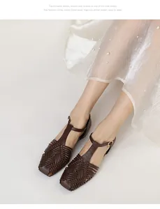 Close-up detail of vintage brown woven T-strap sandals styled with a white skirt