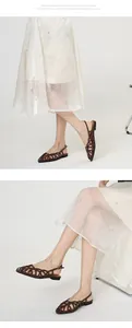 Detailed view of brown woven Roman sandals with an elegant buckle slingback strap.